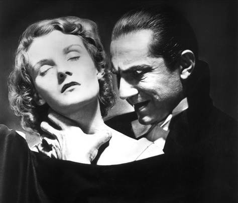 Actor Bela Lugosi, who played an iconic Dracula, prepares to bite the neck of an unconscious young woman in the 1931 movie "Dracula."