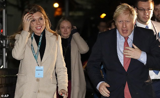 Boris Johnson and his partner Carrie Symonds arrive at the election count in his Uxbridge constituency in suburban London AFP