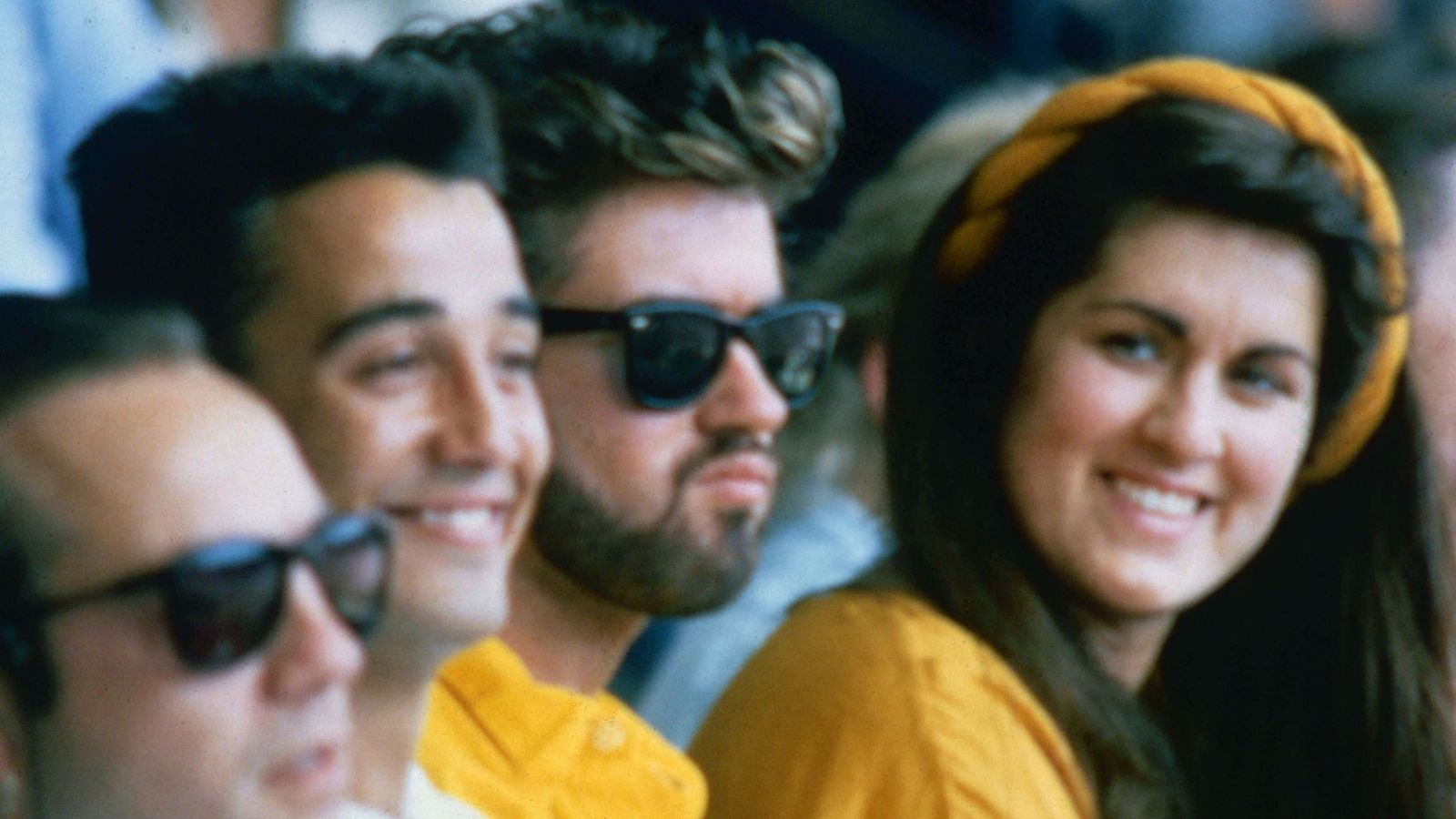 George Michael with Andrew Ridgeley and sister Melanie Panayiotou at Live Aid in 1985
