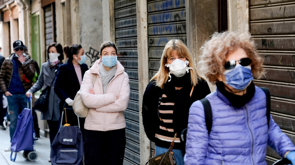 Customers queue at a fish market in Venice, Italy as new restrictions for open-air markets are implemented to prevent the spread of the coronavirus [Manuel Silvestri-Reuters]