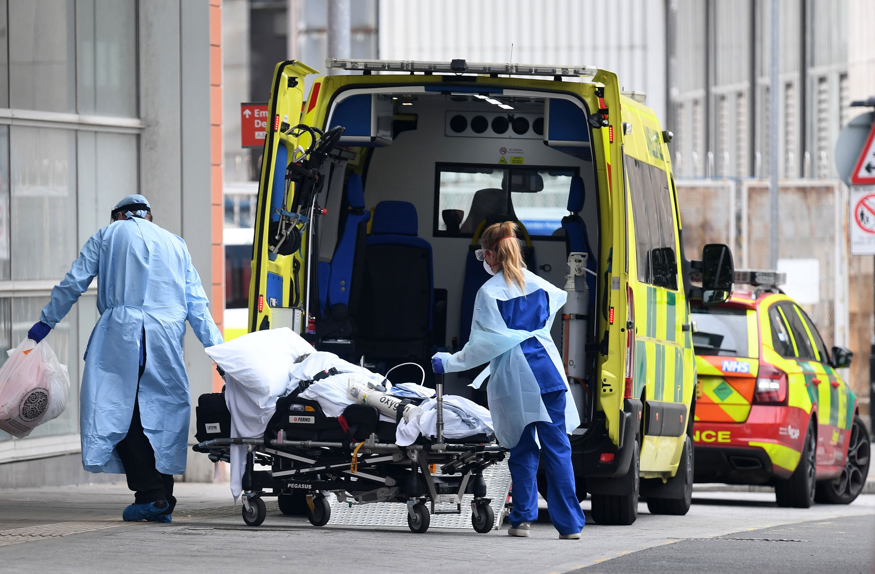 Health workers wear PPE as they transfer a patient from an ambulance into The Royal London Hospital in east London on April 18, 2020, during the novel coronavirus COVID-19 pandemic. - Britain's death toll from the coronavirus rose by 847 on Friday, health ministry figures showed, a slightly slower increase than the previous day but still among the worst rates globally. (Photo by DANIEL LEAL-OLIVAS / AFP) (Photo by DANIEL LEAL-OLIVAS/AFP via Getty Images)